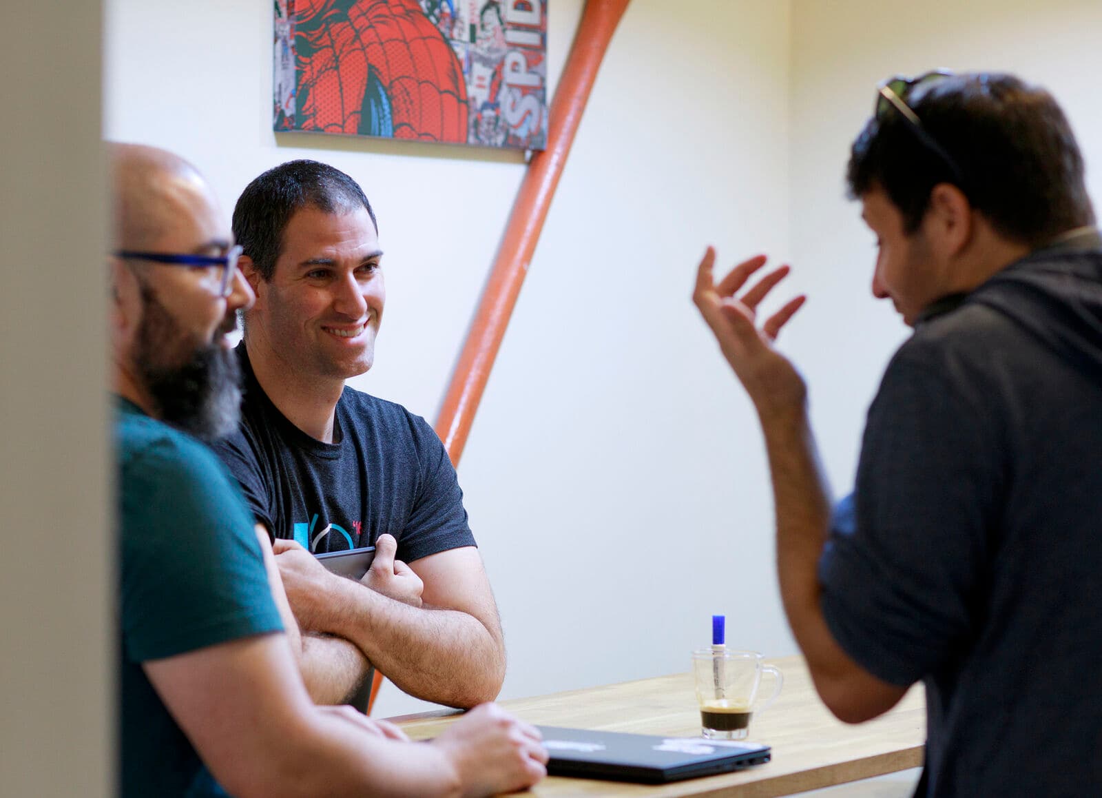 DoiT team collaborating around a laptop